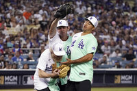 Rapper and Singer Bad Bunny walks in the outfield during the MLB All Star Celebrity Softball game, Saturday, July 16, 2022, in Los Angeles. (AP Photo/Mark J. Terrill)