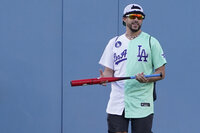 Rapper and Singer Bad Bunny walks in the outfield during the MLB All Star Celebrity Softball game, Saturday, July 16, 2022, in Los Angeles. (AP Photo/Mark J. Terrill)