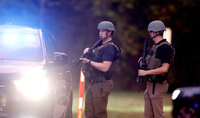 Law enforcement officers block off Old Milburnie Road during a shooting in Raleigh, N.C., Thursday, Oct. 13, 2022. (Robert Willett/The News & Observer via AP)