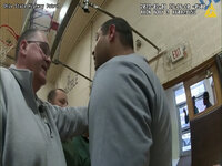 This photo provided by Ohio State Highway Patrol shows police bodycam footage of NewsNation correspondent Evan Lambert interaction with the leader of the Ohio National Guard Wednesday, Feb. 8, 2023 in the gymnasium of an elementary school in East Palestine, Ohio. Lambert was charged with criminal trespass and resisting arrest after authorities said he was told to stop his live broadcast and then refused their orders to leave the news conference with Ohio Gov. Mike DeWine. (Ohio State Highway Patrol via AP)