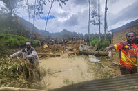 Villagers use heavy machinery to search through a landslide in Yambali in the Highlands of Papua New Guinea, Sunday, May 26, 2024. The International Organization for Migration feared Sunday the death toll from a massive landslide is much worse than what authorities initially estimated. (Mohamud Omer/International Organization for Migration via AP)