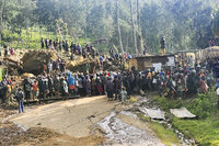 In this photo provided by the UNDP Papua New Guinea, villagers carry a coffin during a funeral procession in Yambali village in the Highlands of Papua New Guinea, Sunday, May 26, 2024. The International Organization for Migration feared Sunday the death toll from a massive landslide is much worse than what authorities initially estimated. (Kafuri Yaro/UNDP Papua New Guinea via AP)