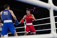 Uzbekistan's Asadkhuja Muydinkhujaev, right, fights Mexico's Marco Verde in their men's 71 kg final boxing match at the 2024 Summer Olympics, Friday, Aug. 9, 2024, in Paris, France. (AP Photo/Ariana Cubillos)