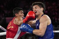 Uzbekistan's Asadkhuja Muydinkhujaev, left, fights Mexico's Marco Verde in their men's 71 kg final boxing match at the 2024 Summer Olympics, Friday, Aug. 9, 2024, in Paris, France. (AP Photo/Ariana Cubillos)