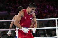 Uzbekistan's Asadkhuja Muydinkhujaev embraces Mexico's Marco Verde after Muydinkhujaev won their men's 71 kg final boxing match at the 2024 Summer Olympics, Friday, Aug. 9, 2024, in Paris, France. (AP Photo/John Locher)