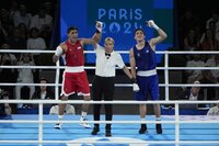 Uzbekistan's Asadkhuja Muydinkhujaev, right, celebrates after defeating Mexico's Marco Verde in their men's 71 kg final boxing match at the 2024 Summer Olympics, Friday, Aug. 9, 2024, in Paris, France. (AP Photo/John Locher)