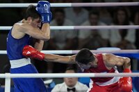 Uzbekistan's Asadkhuja Muydinkhujaev, right, fights Mexico's Marco Verde in their men's 71 kg final boxing match at the 2024 Summer Olympics, Friday, Aug. 9, 2024, in Paris, France. (AP Photo/John Locher)