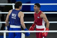 Uzbekistan's Asadkhuja Muydinkhujaev, left, fights Mexico's Marco Verde in their men's 71 kg final boxing match at the 2024 Summer Olympics, Friday, Aug. 9, 2024, in Paris, France. (AP Photo/Ariana Cubillos)