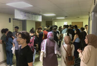 People gather outside the American University hospital after the arrival of several men who were wounded by exploded handheld pagers, in Beirut, Lebanon, Tuesday, Sept. 17, 2024. (AP Photo/Bassam Masri)