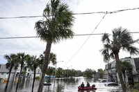 A water rescue boat moves in flood waters at an apartment complex in the aftermath of Hurricane Milton, Thursday, Oct. 10, 2024, in Clearwater, Fla. (AP Photo/Mike Stewart)