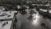 A water rescue team member walks through flood waters at an apartment complex in the aftermath of Hurricane Milton, Thursday, Oct. 10, 2024, in Clearwater, Fla. (AP Photo/Mike Stewart)