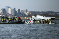 National Transportation Safety Board (NTSB) investigators examine cockpit voice recorder and flight data recorder recovered from the American Airlines passenger jet that crashed with an Army helicopter Wednesday night near Washington, D.C, Thursday, Jan. 30, 2024. (NTSB via AP)