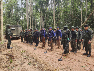 In this photo released by the Royal Thai Army, Thai soldiers inspect a border area on Sunday, July 20, 2025, in Ubon Ratchathani province, where the Royal Thai Army said two anti-personnel landmines were found. (Royal Thai Army via AP)