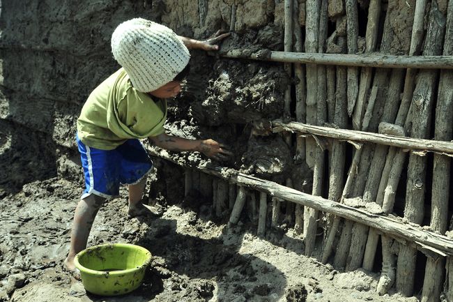 Desarrollo. Un pequeño de cinco años ayuda a construir su vivienda hecha con palos y lodo. Según el reporte de la Cepal, las mujeres y los niños son los más vulnerables a la pobreza en América Latina. (NOTIMEX)