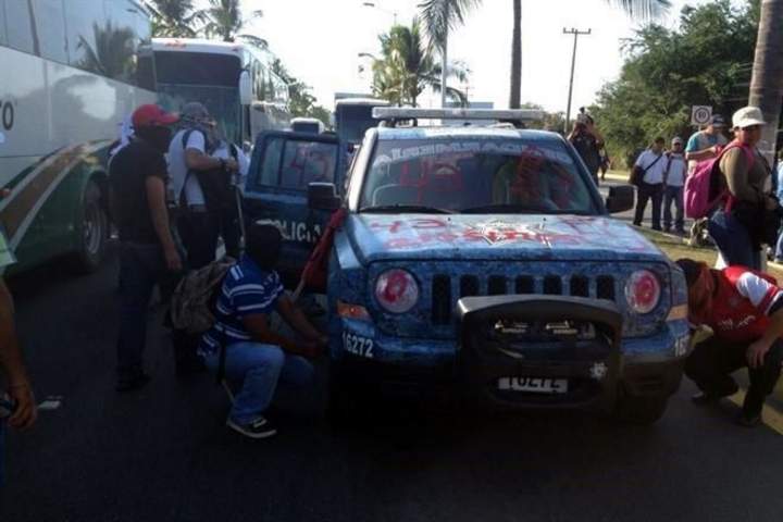 Al manifestarse frente al aeropuerto de Acapulco en demanda de pagos y por normalistas, maestros vandalizaron un vehículo de Gendarmería.