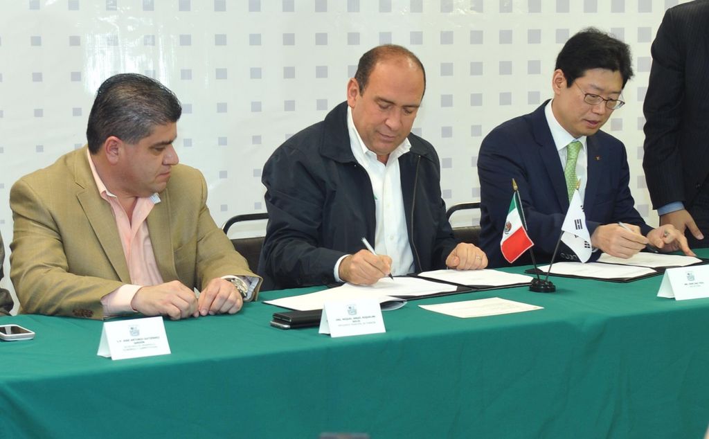 Convenio. El gobernador Rubén Moreira (c) y el director ejecutivo de Yura, Dae-Yeol Ohm (d), firman el convenio de concertación para la inversión de una planta de autopartes en Torreón. En la imagen aparece también el alcalde Miguel Riquelme.