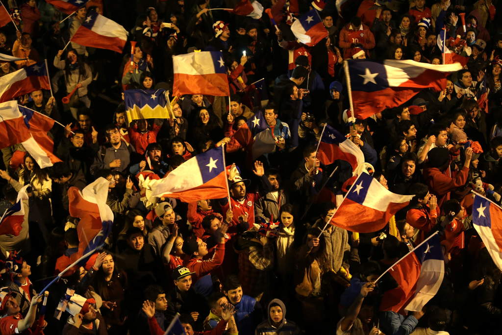 Hinchas chilenos celebran el triunfo de su selección nacional en las calles de Concepción. (EFE)
