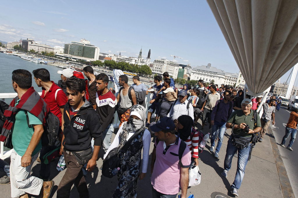 A pie. Refugiados decidieron caminar para llegar a la frontera con Austria debido a la poca disponibilidad del gobierno húngaro de apoyo. 