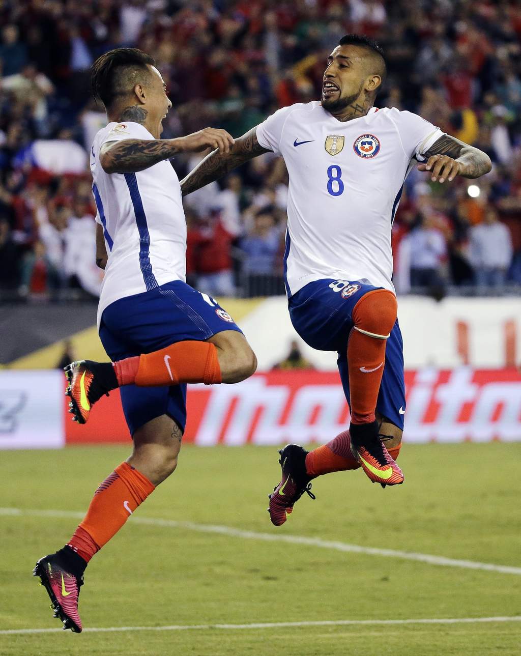 Arturo Vidal (d) de Chile celebra con un compañero después de anotar contra Bolivia, en un partido del grupo D de la Copa América Centenario. (AP)