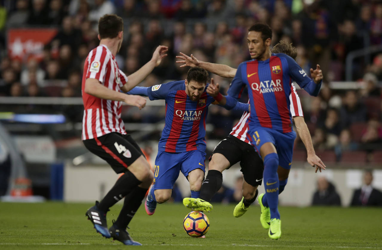 Lionel Messi y Neymar buscan pasar entre los defensores del Athletic de Bilbao, en el partido de ayer. (AP)