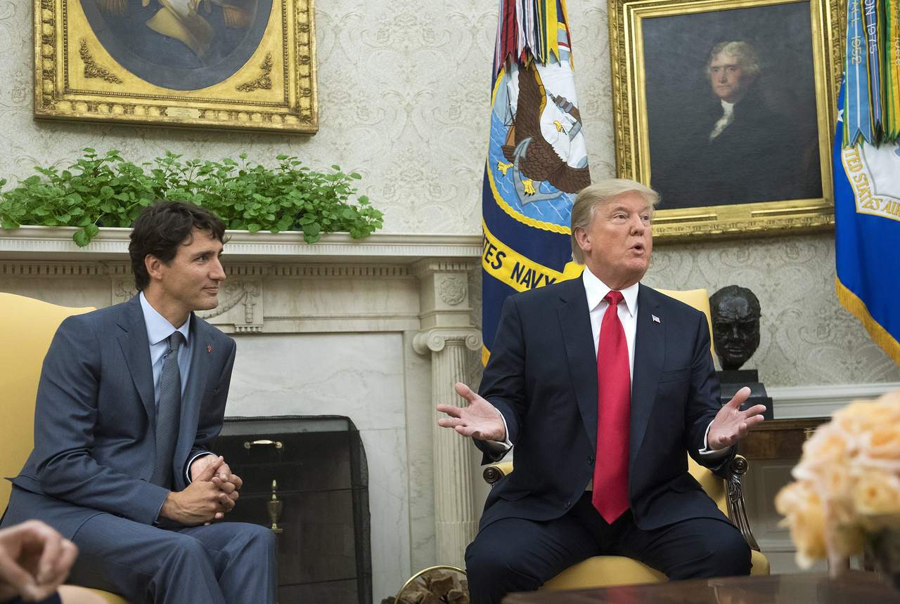 El encuentro entre Trump (der.) y Trudeau (izq.) se produjo a la vez que los jefes negociadores de los tres países iniciaban ayer su cuarta ronda de conversaciones en Virginia. (EFE)