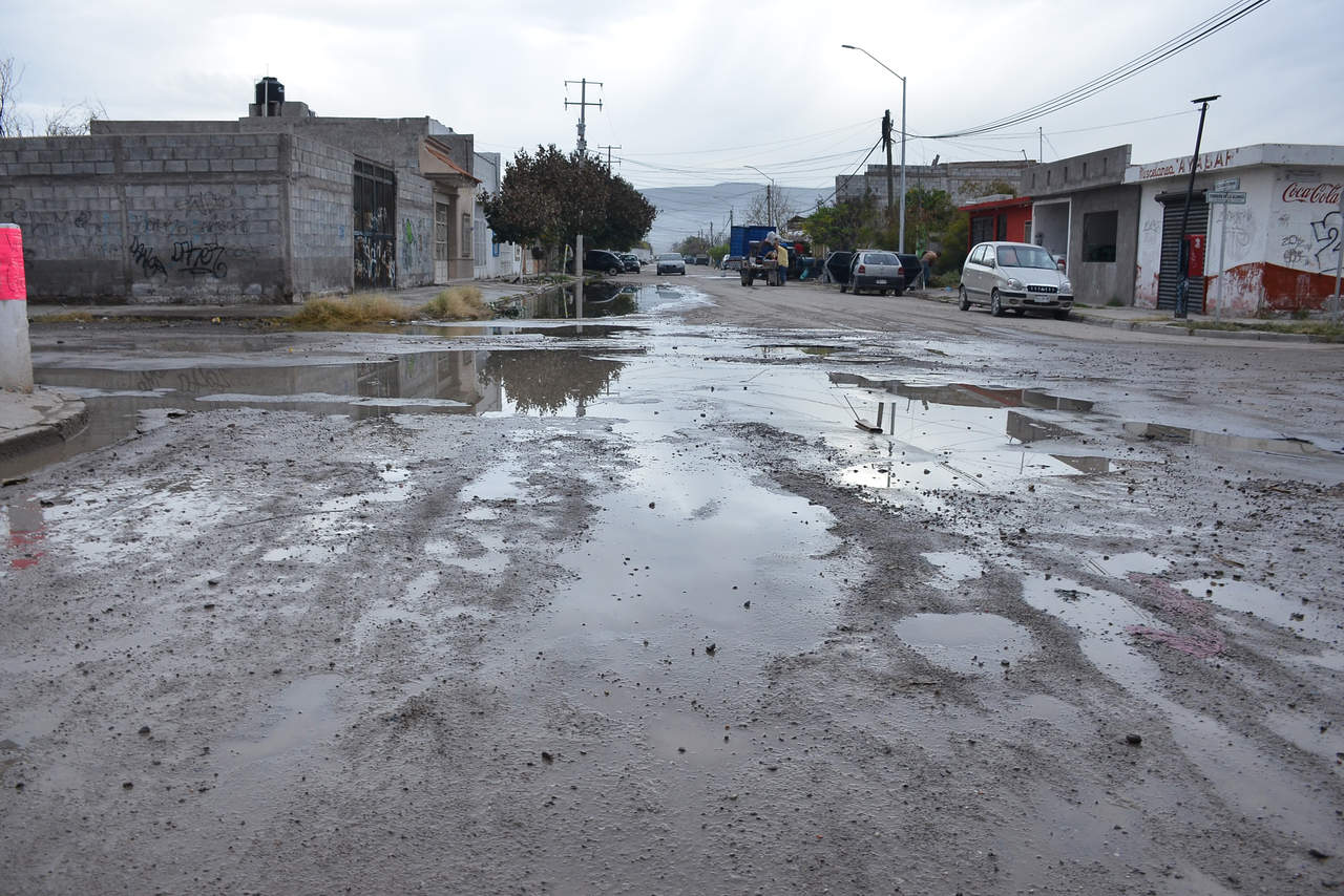 Deterioro. En calzada Hacienda del Torreón y Torreón de la Alianza, de Rincón La Merced, es común encontrar baches que se esconden tras las aguas del drenaje. (EL SIGLO DE TORREÓN)
