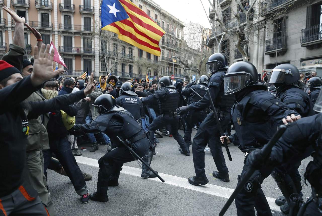 Miembros de los Mossos d'Esquadra impiden el paso de manifestantes en las inmediaciones de la Delegación del Gobierno en Cataluña. (EFE)