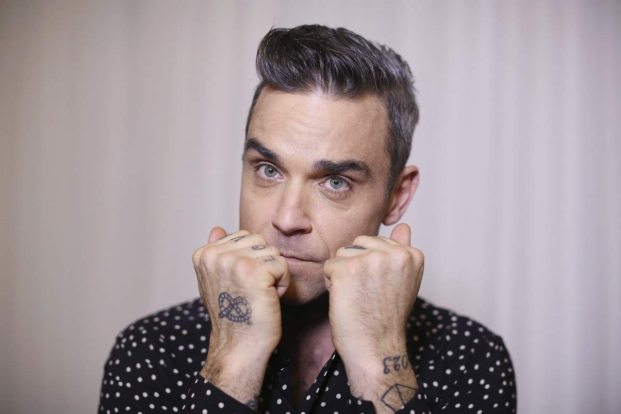 El cantante británico Robbie Williams confesó hoy que cree que padece el síndrome de Asperger. (ARCHIVO)