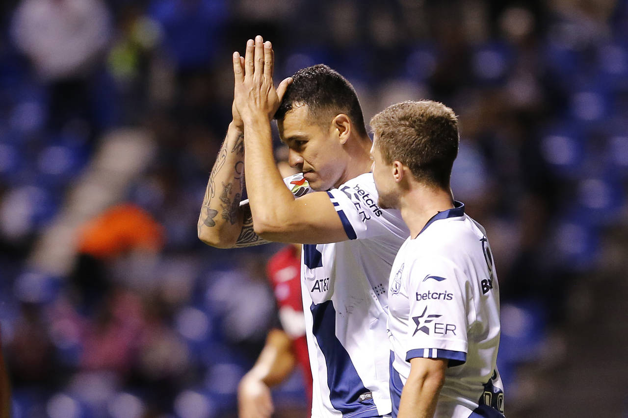 Daniel Arreola, del Puebla, en festejo después del segundo gol de su equipo durante el partido de anoche. Puebla vence a un Atlas inofensivo