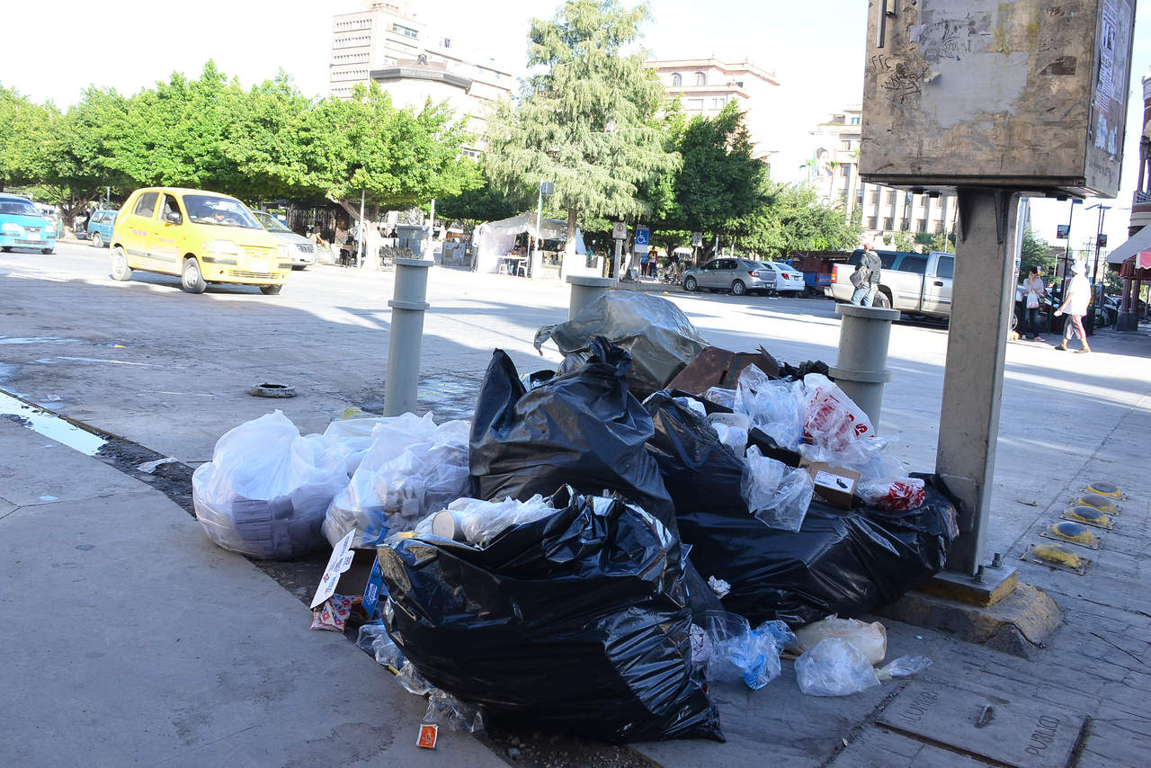 La zona Centro de Torreón amaneció con bolsas de basura pese a la recomendación de sacarla hasta las 19:00 horas por el nuevo horario de recolección. (FERNANDO COMPEÁN) 
