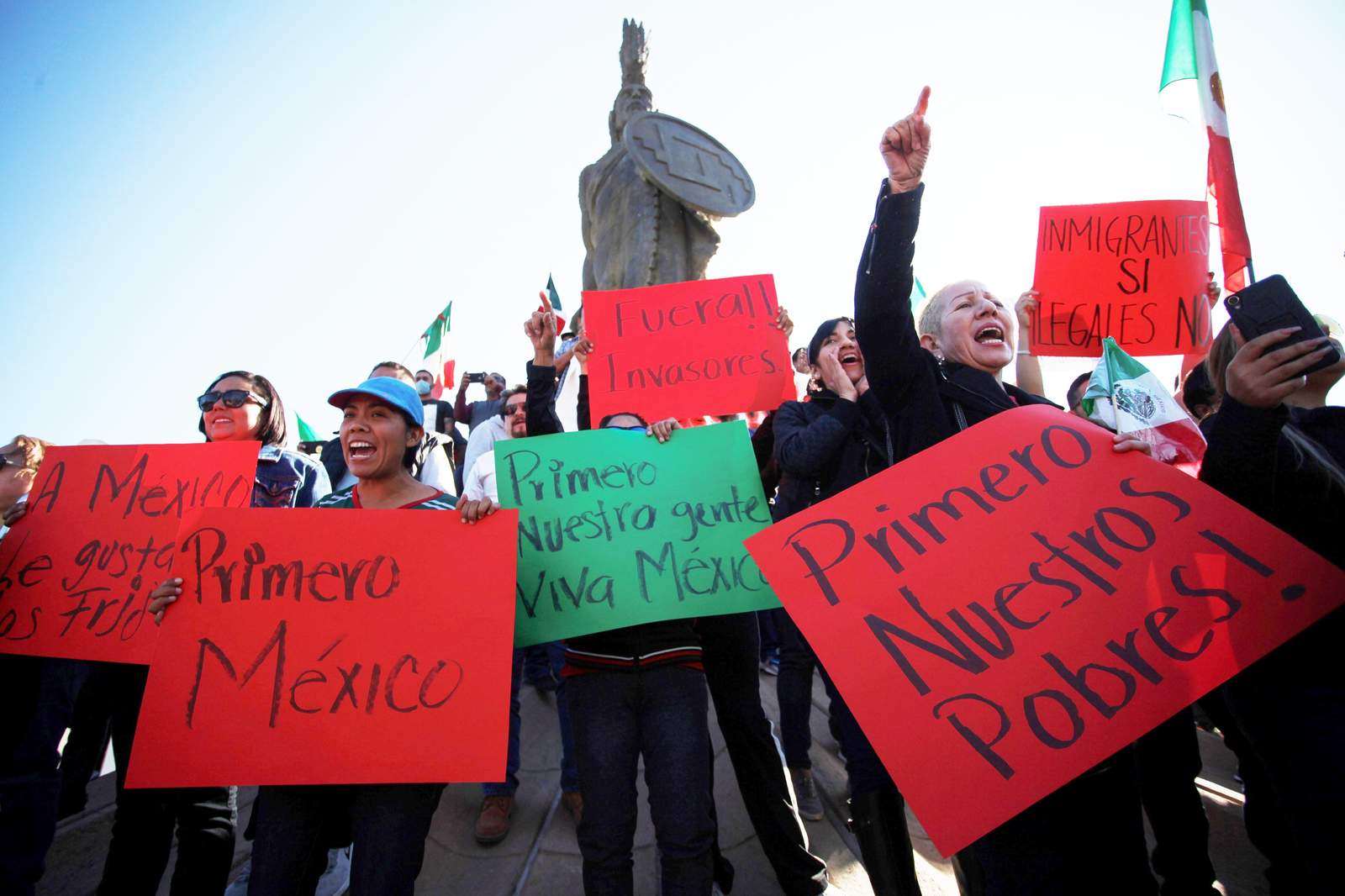 Manifestantes gritan consignas durante una protesta en contra de la presencia de migrantes centroamericanos, que esperan el arribo de otras caravanas para solicitar asilo en Estados Unidos.  (EFE) 