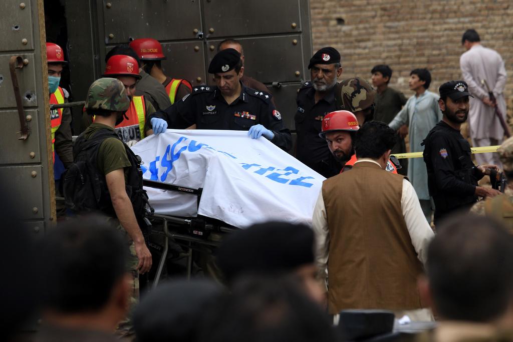 Policías y soldados rodearon la casa en Peshawar el lunes por la noche, pidiendo a los sospechosos que se rindieran. (EFE)