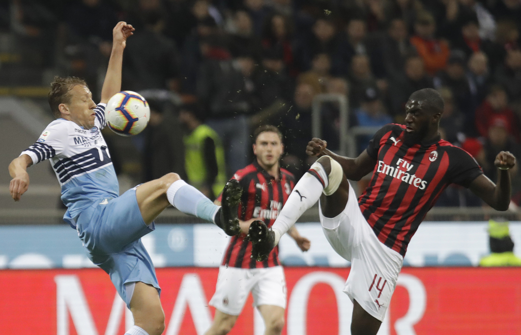 Lucas Leiva (i), de la Lazio, pugna un balón con Tiemoue Bakayoko, del Milán, en un partido de la Serie A de italia, el sábado 13. (AP)