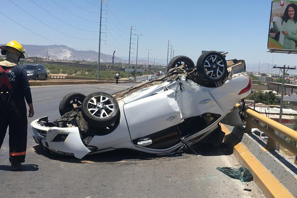 El vehículo Nissan Versa de color blanco se subió al camellón central, derribó una luminaria y terminó sobre su toldo en los carriles contrarios del bulevar Torreón-Matamoros. (EL SIGLO DE TORREÓN)