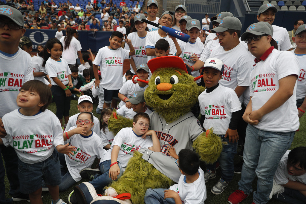 Orbit, la mascota de los Astros de Houston, posa con los participantes del evento Play Ball de las Grandes Ligas para niños de 5 a 13 años, durante la serie que se llevó a cabo en Monterrey. (AP)