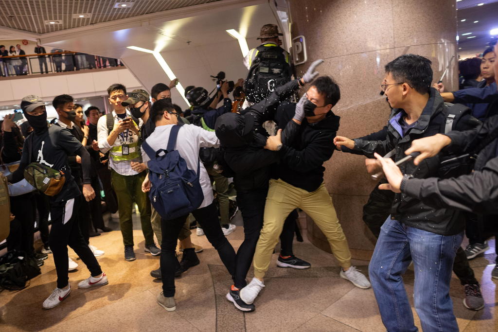 Gases lacrimógenos, enfrentamientos en los centros comerciales y decenas de heridos se desarrollan a pocas horas de la Navidad en Hong Kong. (EFE) 