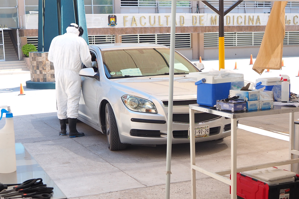 La toma de muestra de detección de COVID-19 se realiza a las personas desde sus vehículos.